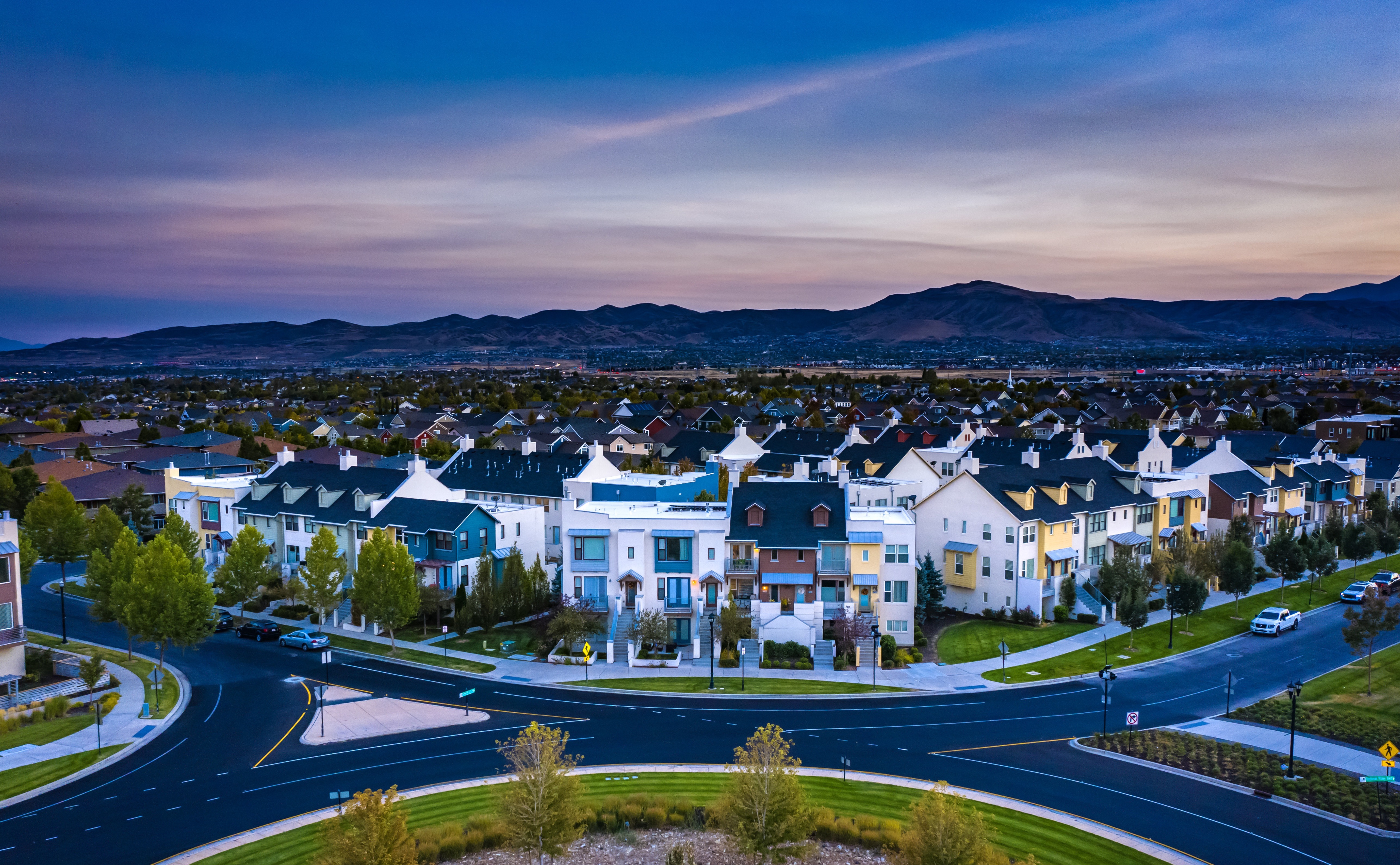 Colorful homes sprawled out in front the mountain lined skyline in South Jordan, Utah